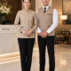 Hotel front office team in a beige jacket and waistcoat at reception